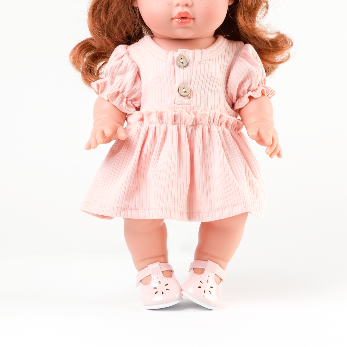 Close-up of rose pink puff sleeve doll dress showing gathered bodice and wooden button detail fits 34-38cm dolls.