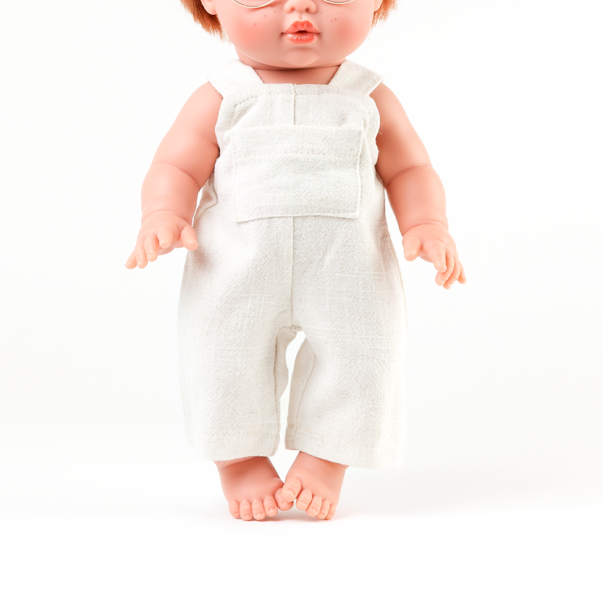 Mini Colettos Jasper wearing the Oat Linen Romper showing its simple linen design for 34-38cm dolls.