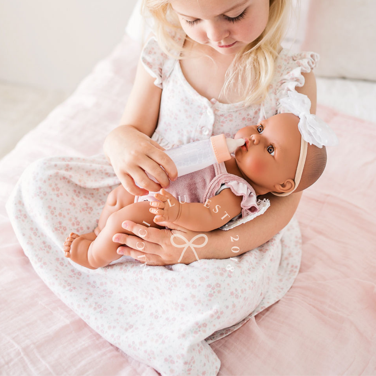 Mini Colettos Alba wearing the Rose Blush Flutter Velvet Singlet Romper in a lifestyle setting.