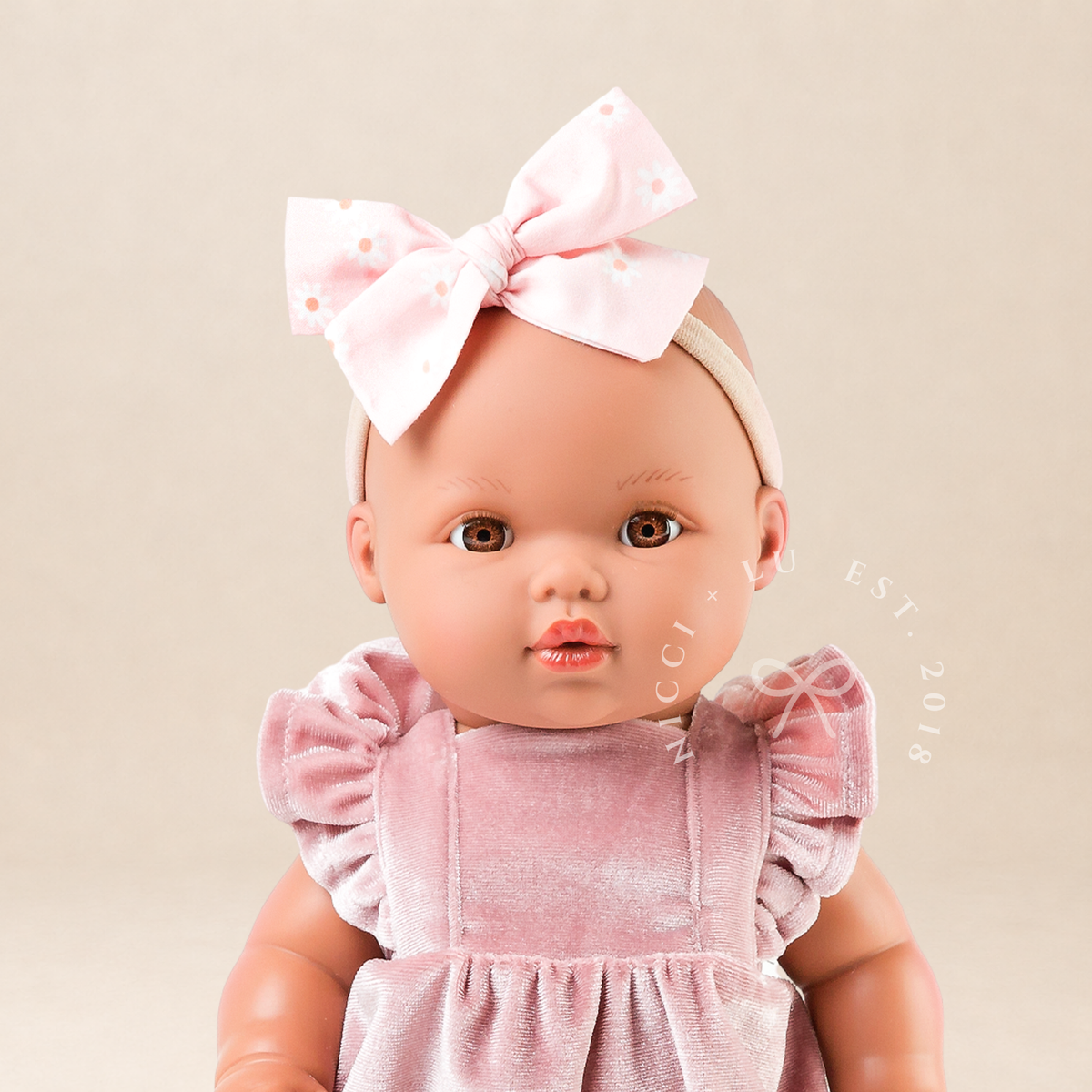 Portrait of Mini Colettos Alba wearing the Rose Blush Velvet Frilled Bubble Playsuit with Gold Mary Jane Shoes for 34-38cm dolls.