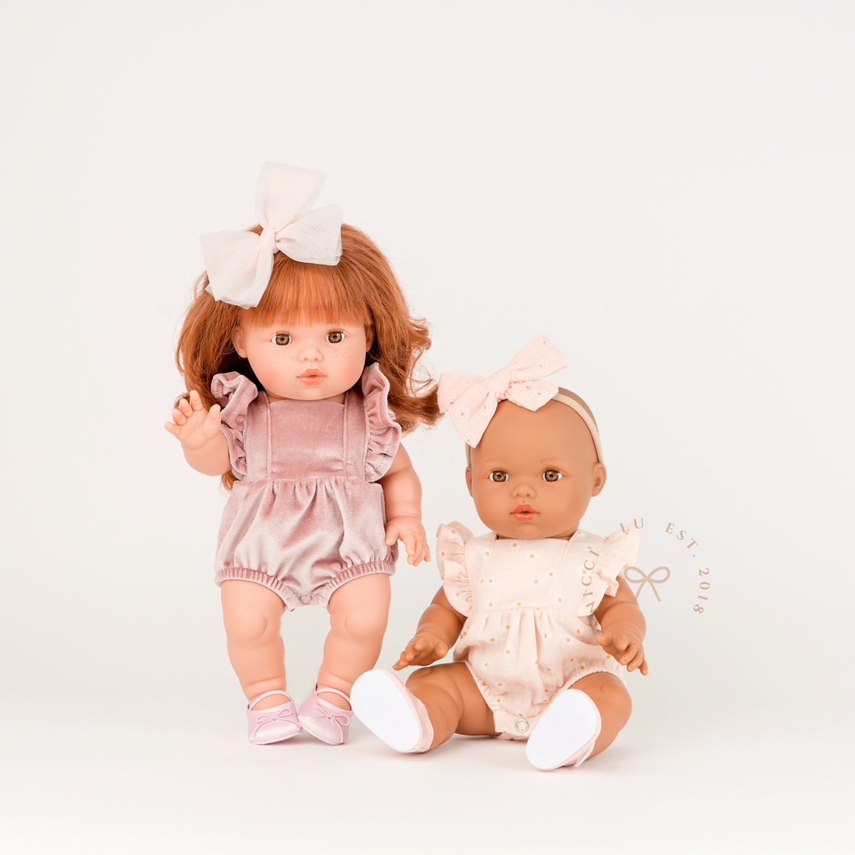 Mini Colettos Alba and Isabel wearing the Frilled Bubble Playsuits in Rose Blush Velvet and Daisy Print Muslin.