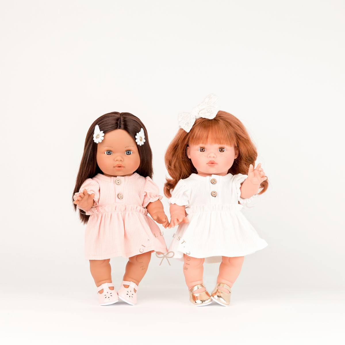 Two 34cm Mini Colettos dolls wearing rose pink and ivory puff sleeve dresses side by side. A  Nicci and Lu doll clothing collection.