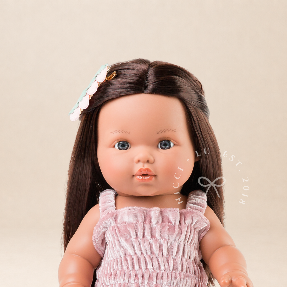 Portrait of Mini Colettos Isabel wearing the Billie Smocked Dress in Rose Blush Velvet with Gold Mary Jane shoes.