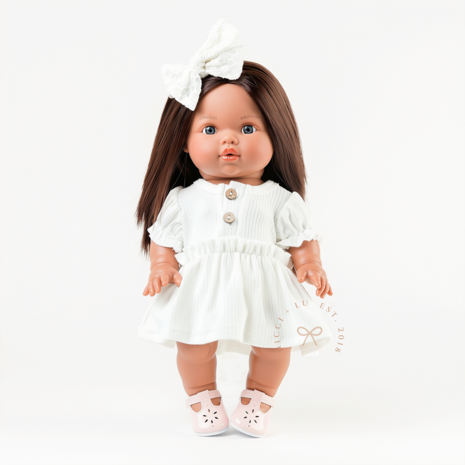 Close-up portrait of 34cm Mini Colettos doll in ivory puff sleeve dress with white bow by Nicci and Lu Australian doll boutique.