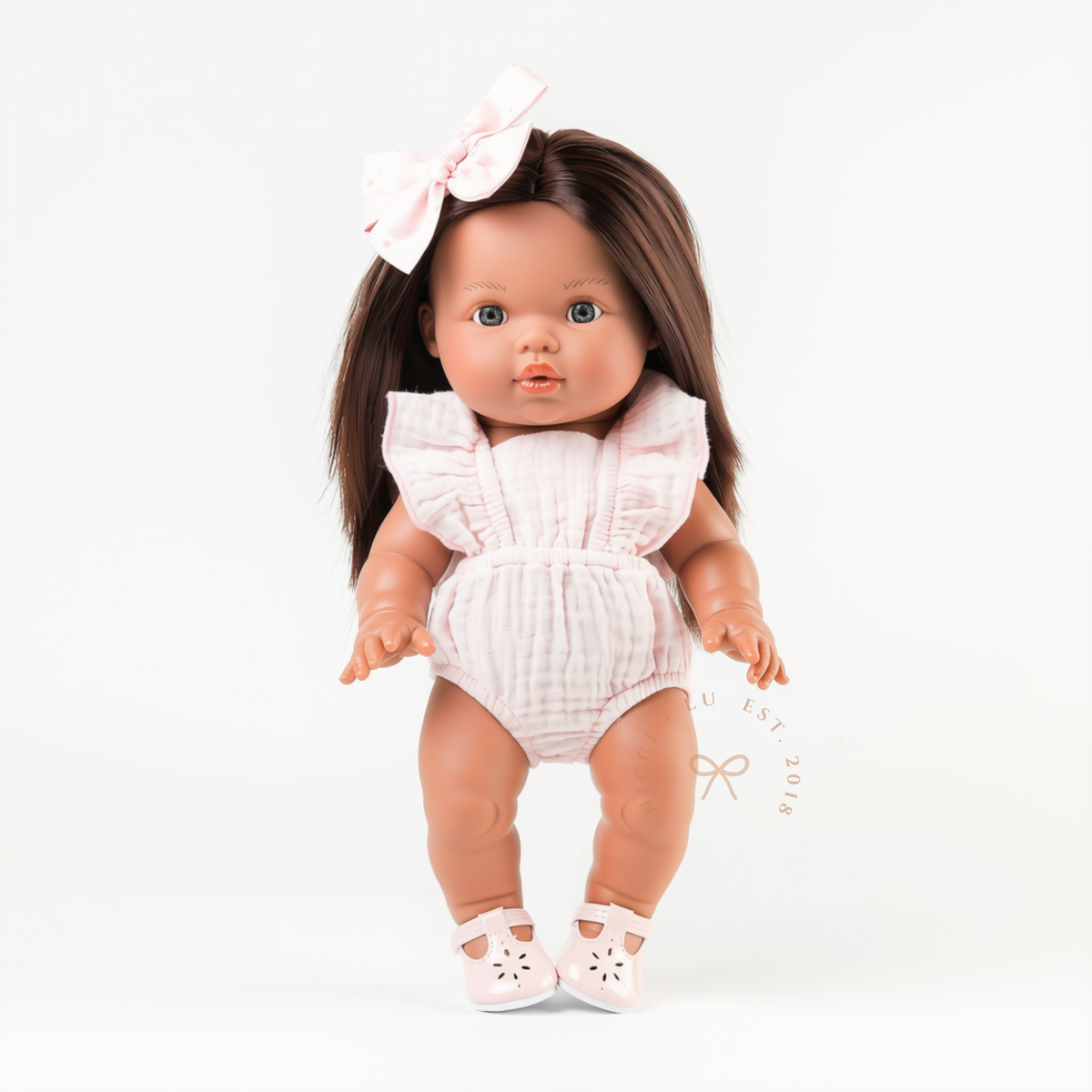 34cm Mini Colettos Isabel wearing the Flutter Romper in Cotton Candy with Soft Pink Mary Jane Shoes.