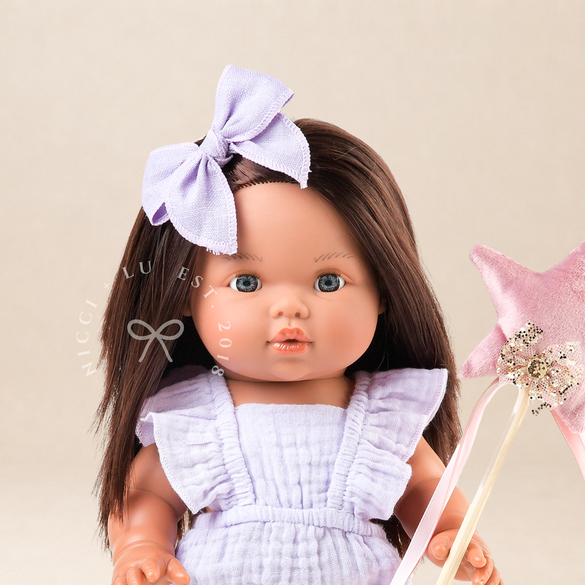 34cm Mini Colettos Isabel wearing the Flutter Romper in Mauve while holding a fairy wand.