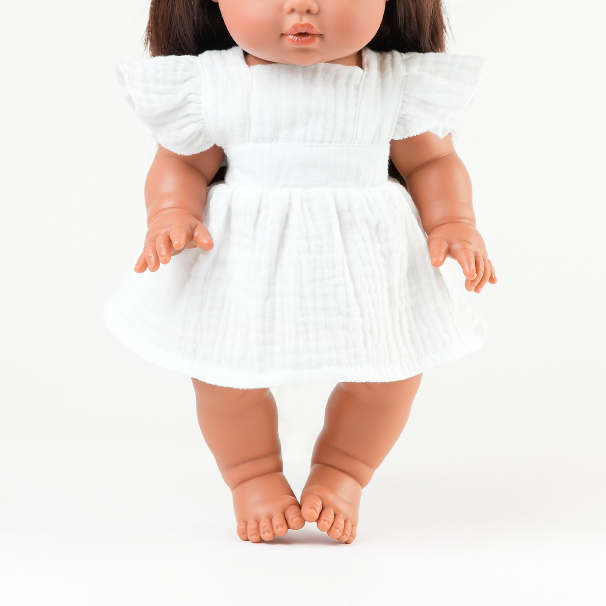 Mini Colettos Isabel doll wearing the Pippa Apron Dress in Ivory for 34-38cm dolls.