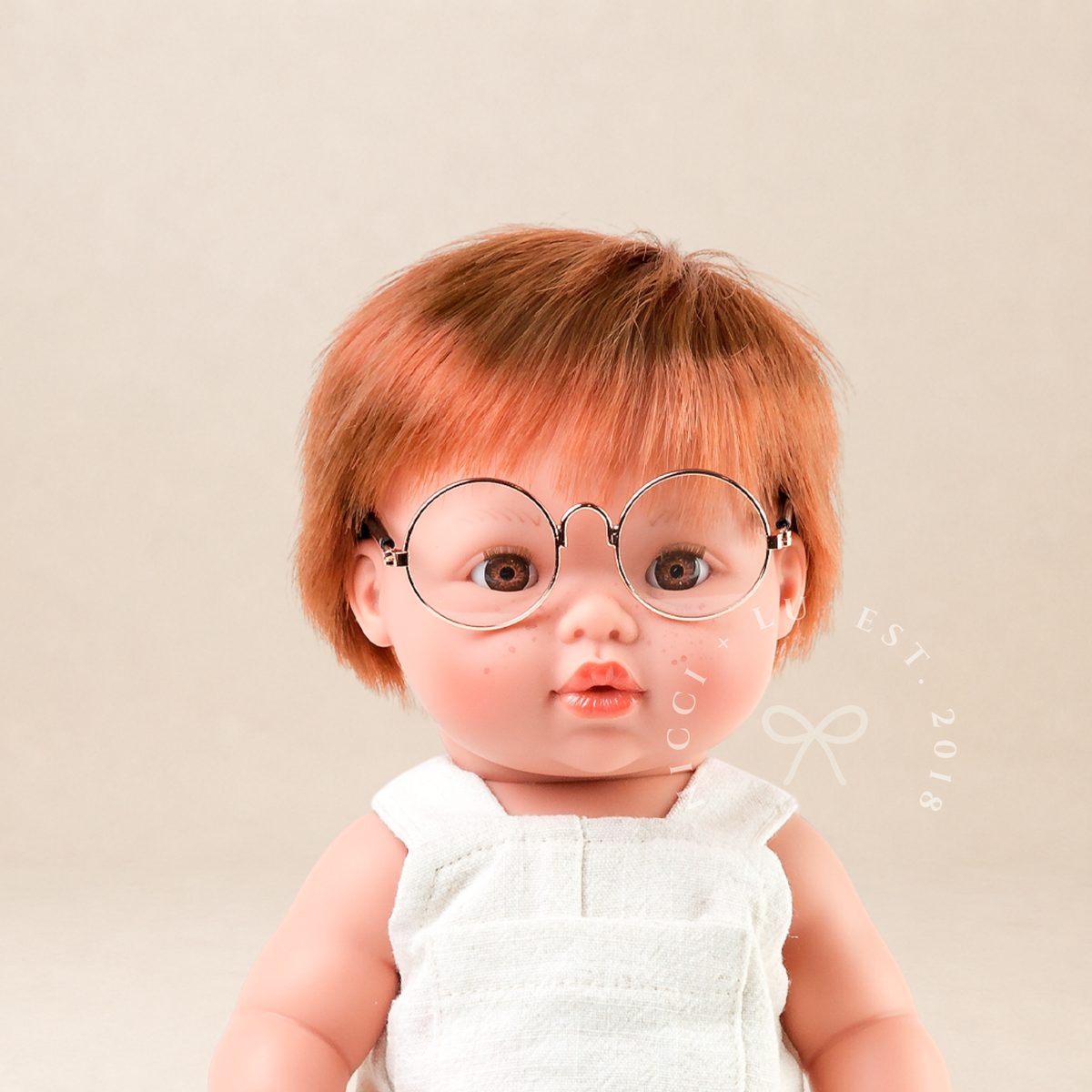 Mini Colettos Jasper wearing the Oat Linen Romper.