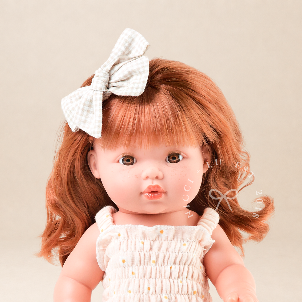 Portrait of Mini Colettos Sophia wearing the Billie Smocked Dress in Daisy Print Muslin.