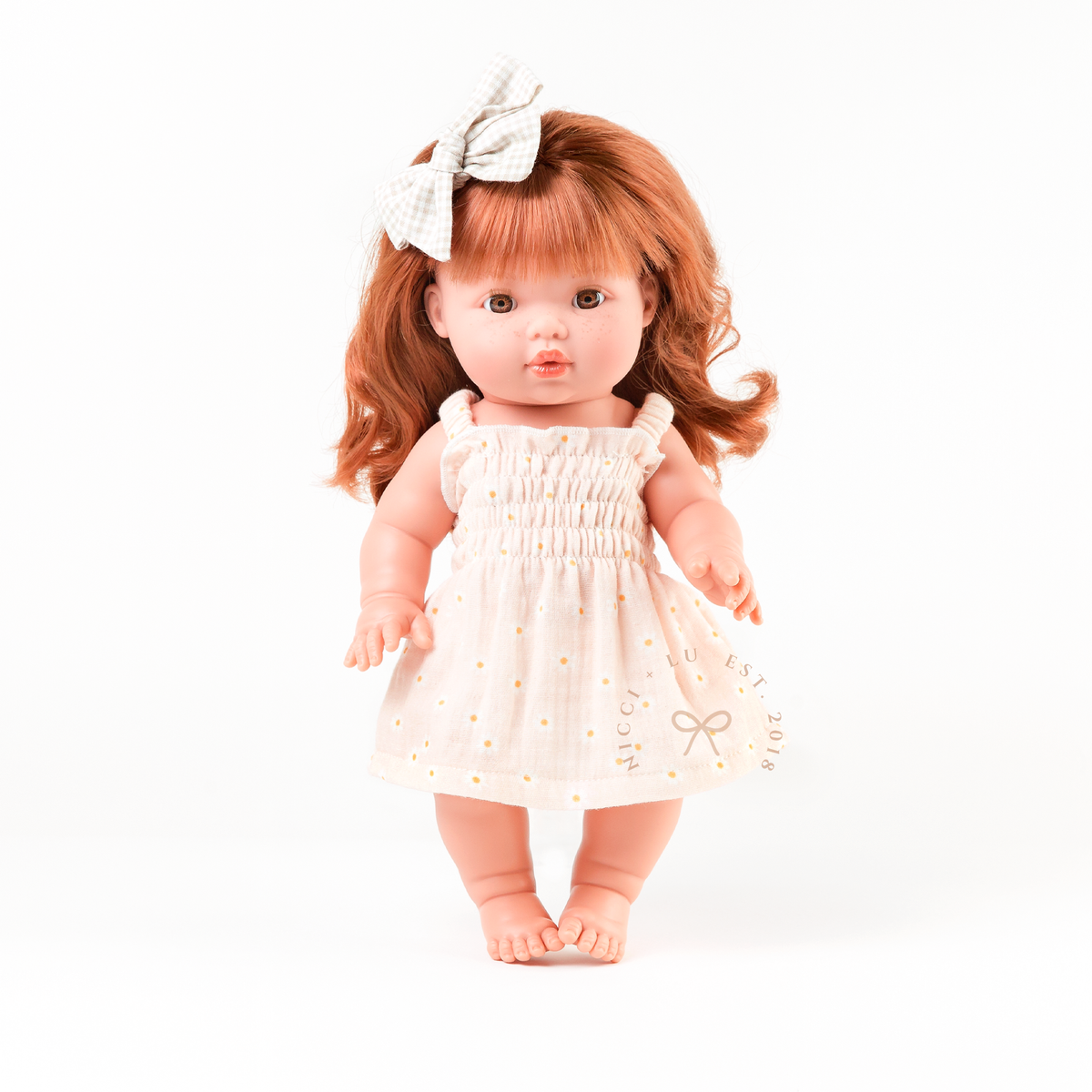 Mini Colettos Sophia wearing the Billie Smocked Dress in Daisy Print Muslin.