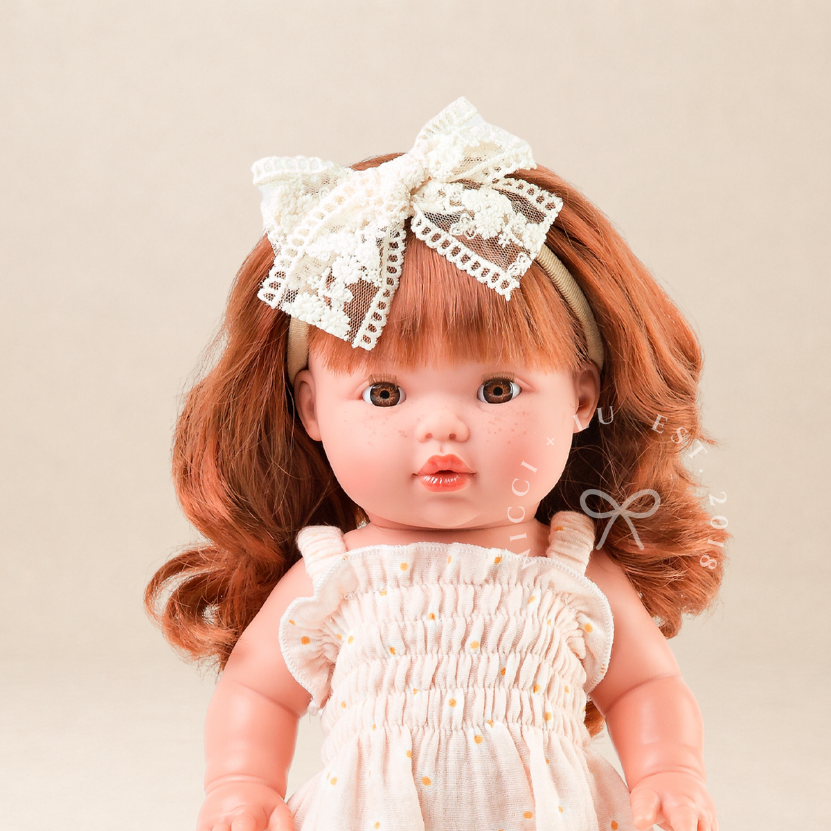 Portrait of Mini Colettos Sophia wearing the Florence Smocked Jumpsuit in Daisy Print Muslin with Gold Mary Jane shoes.