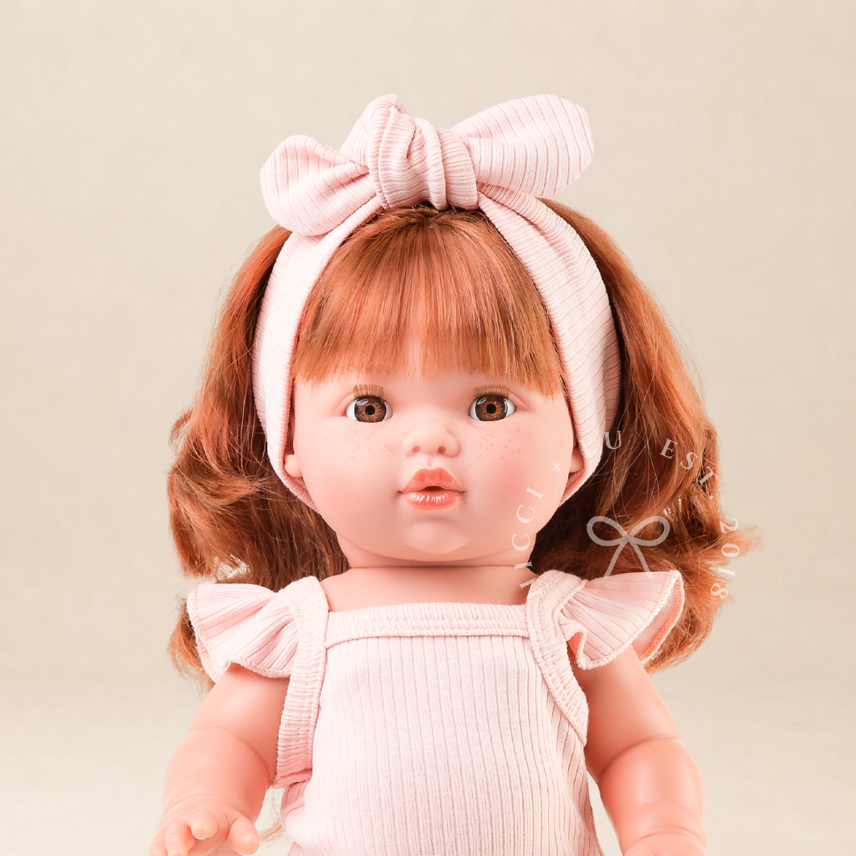 Mini Colettos Sophia wearing the Rose Pink Flutter Singlet Romper and matching headband.