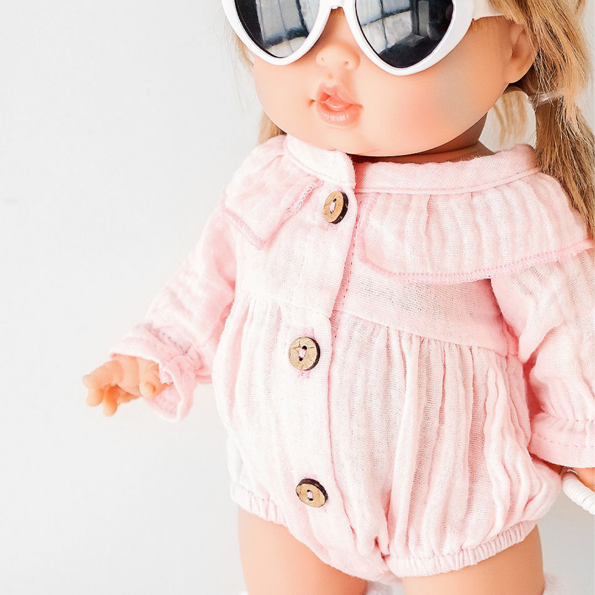 Close-up of Daisy Muslin Playsuit collar and wooden buttons on 34cm Minikane doll - doll clothing and outfits by Nicci and Lu.
