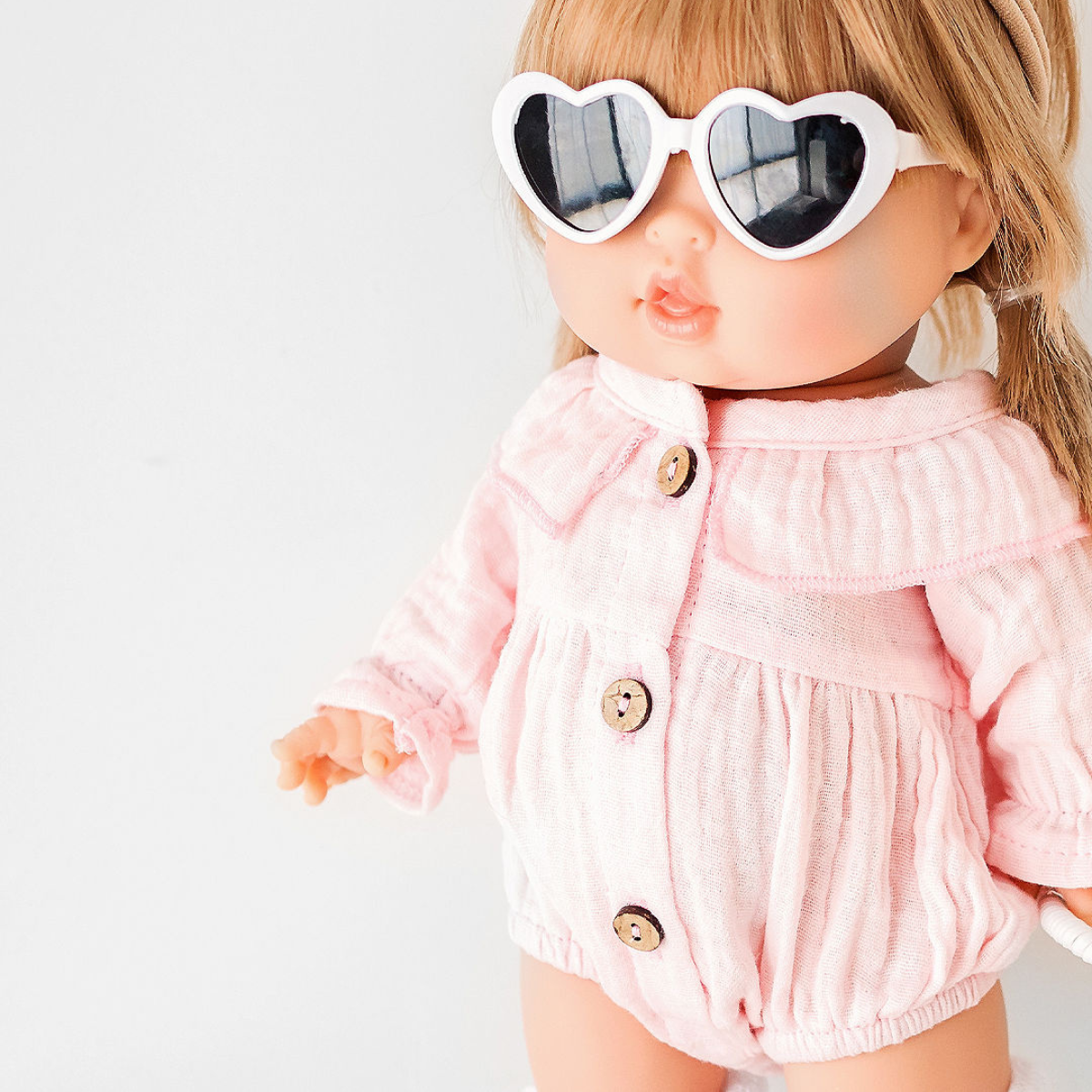 34cm Minikane Mini Coletto Doll wearing a pink outfit and heart-shaped sunglasses on a white background
