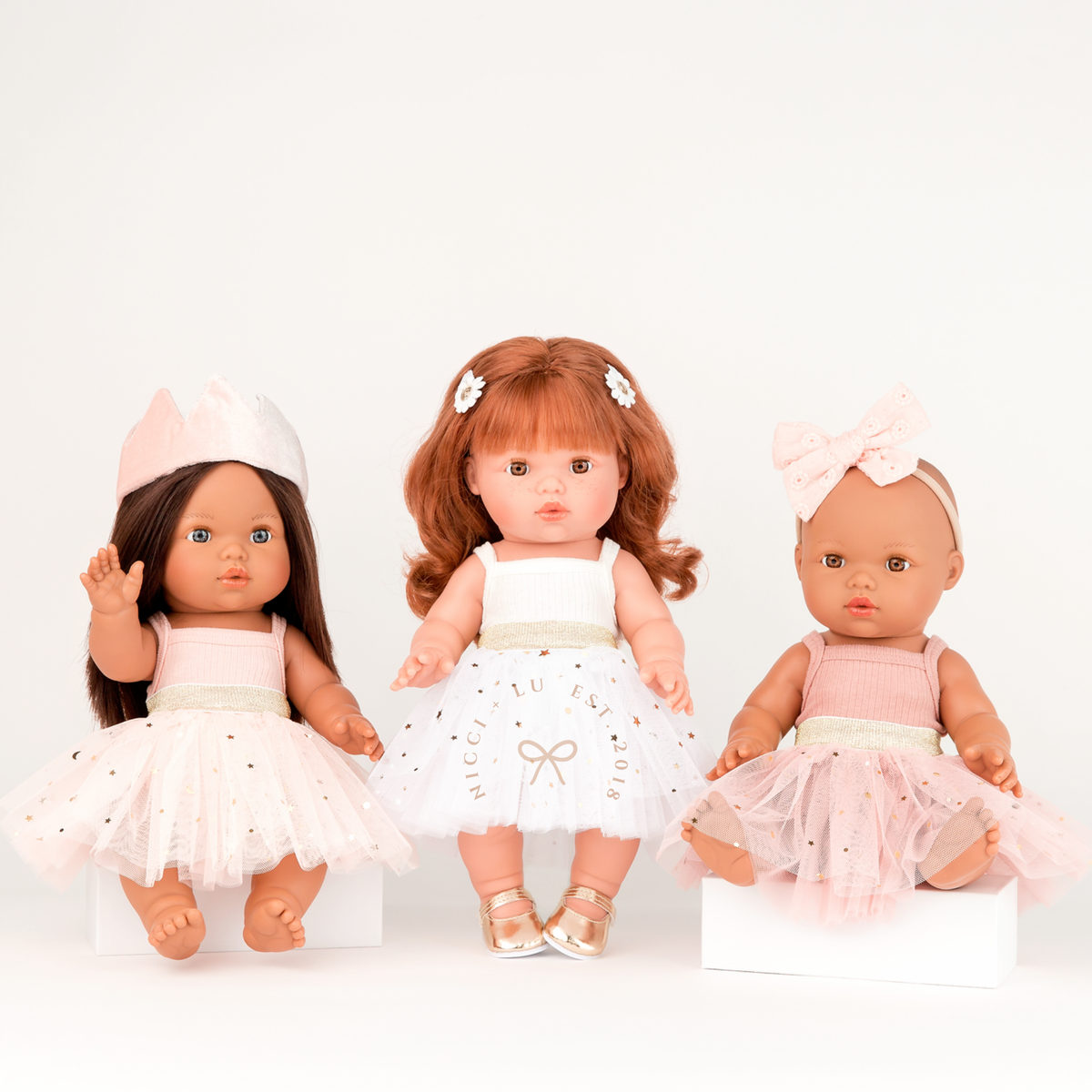 Mini Colettos Isabel, Sophia and Alba dolls wearing the Ivory, Peach and rose blush Tulle Tutu Skirts paired with coordinating doll outfits for 34-38cm dolls.