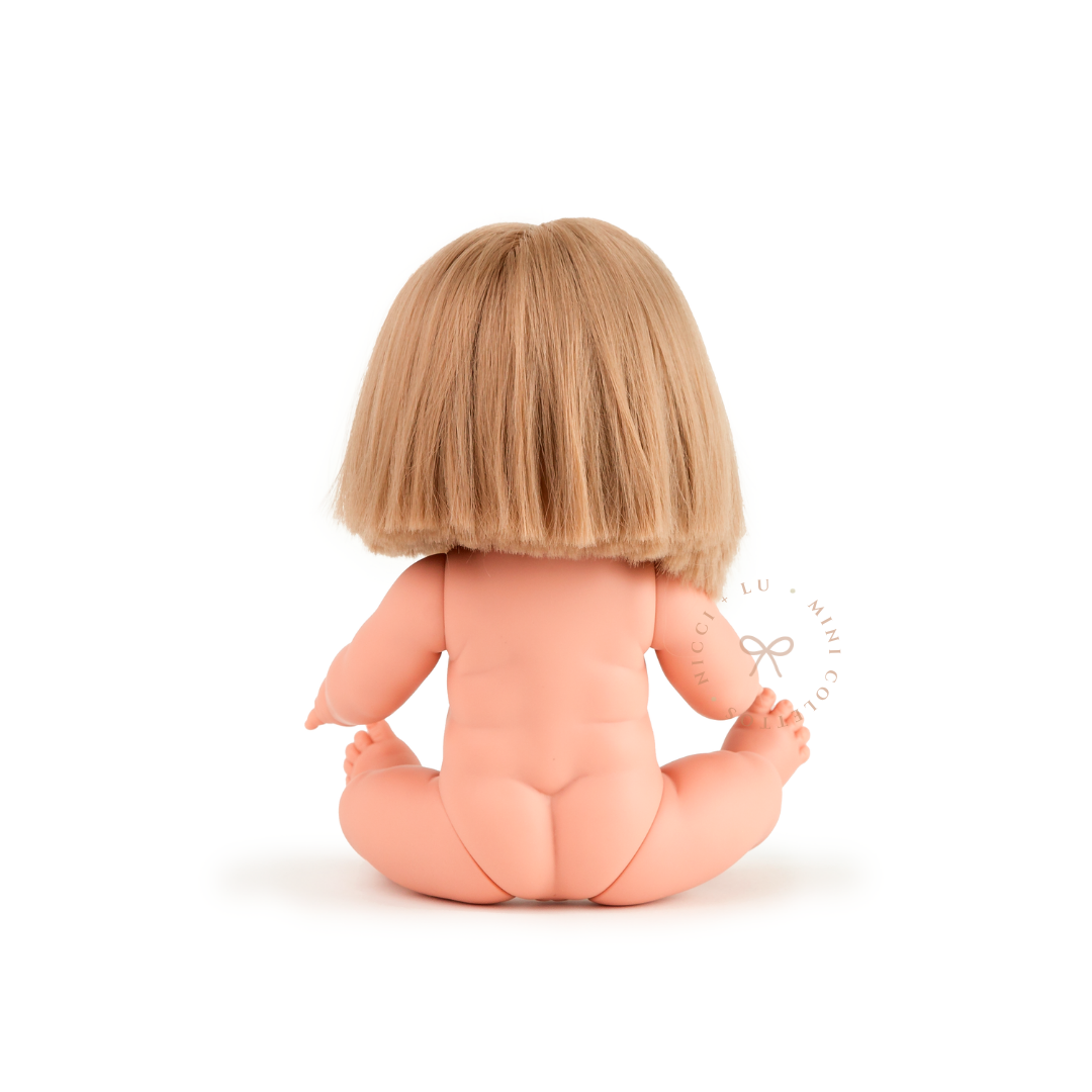 The back view of Charlotte showcases her neatly cut blonde bob hairstyle and anatomically correct doll body. This photograph highlights the short, straight hair design of the 34cm Mini Colettos Charlotte doll.