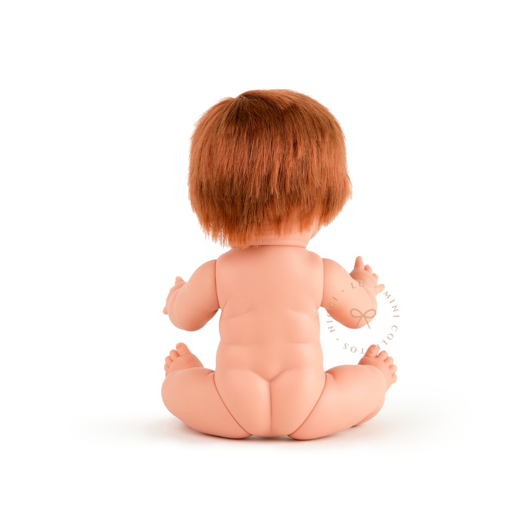 The back view of Jasper highlights his short copper-red hairstyle and anatomically correct doll body. This photograph provides a clear view of the 34cm Mini Colettos Jasper doll from behind.