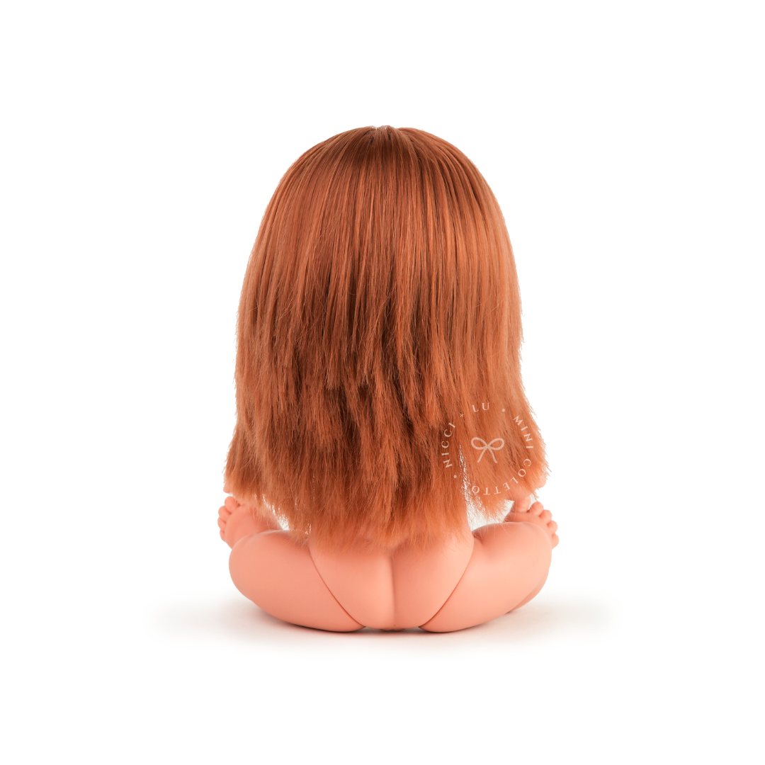 The back view of Nicole showcases her long, smooth copper-red hair flowing down her back. This photograph highlights the hair length and anatomically correct design of the 34cm Mini Colettos Nicole doll.