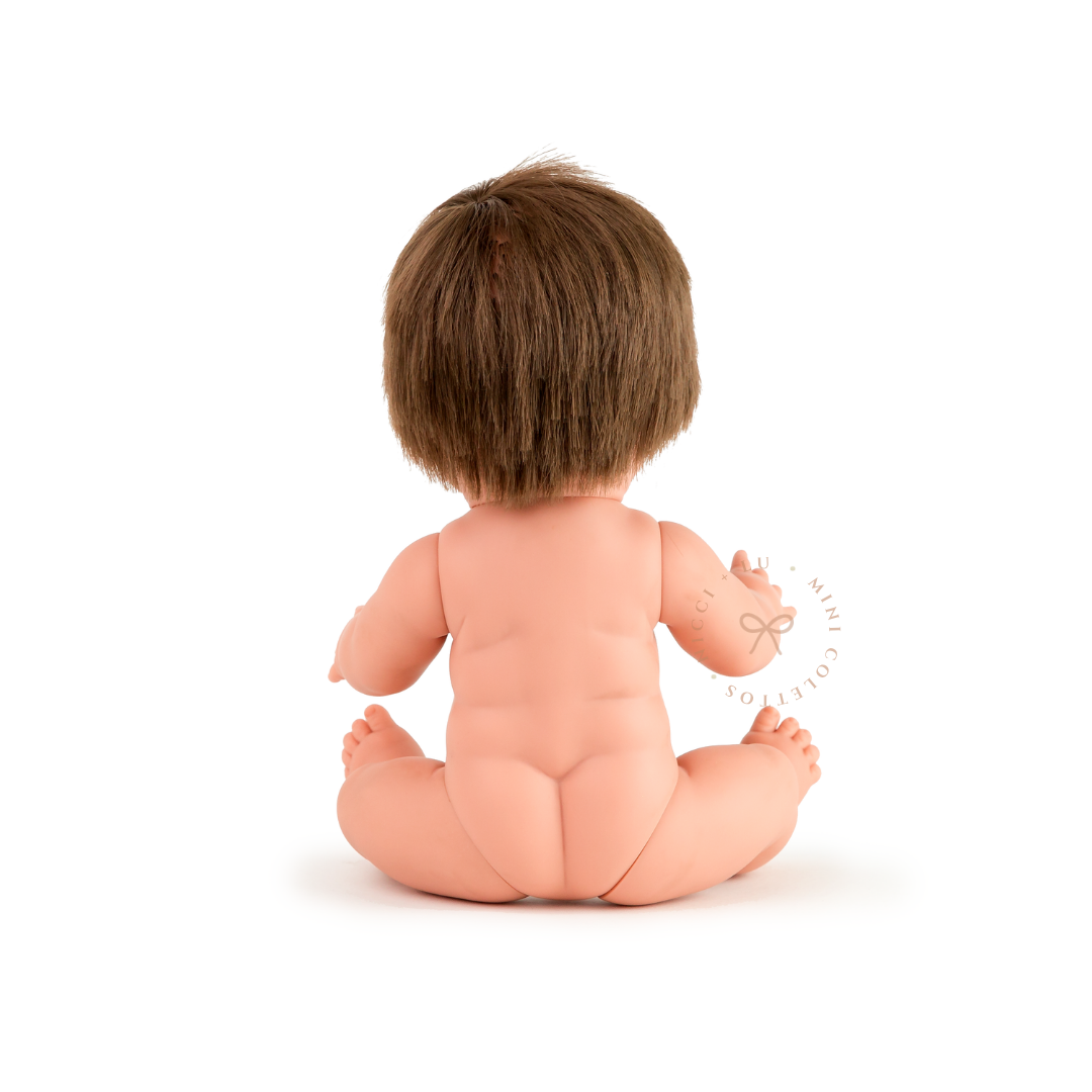Rear view of Mini Colettos Rafael seated undressed, showing his short straight light brown hair.
