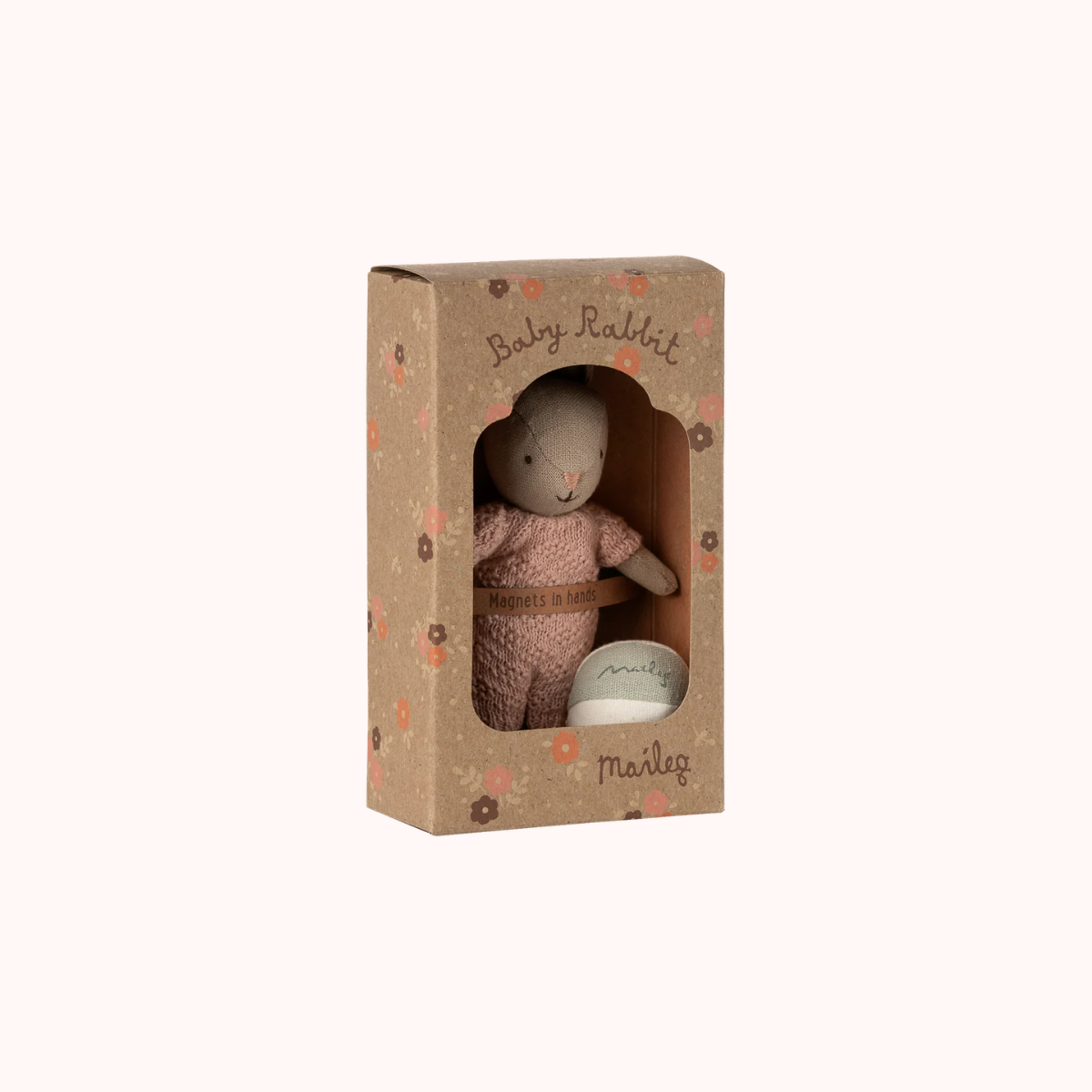 Close-up of the Maileg micro rabbit gift set showing delicate details, magnetic hands and a small ball for play. Stuffed rabbit toy in a cardboard box with 'Maileg' branding