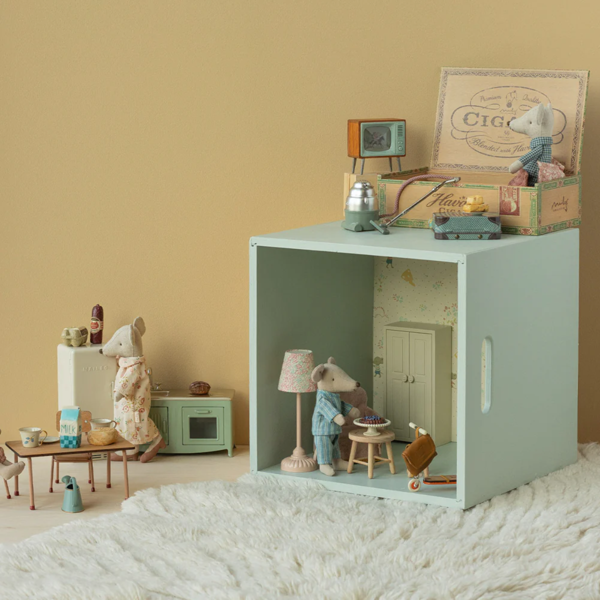 Maileg Grandma and Grandpa Mice in Cigarbox Miniature dollhouse with furniture and accessories on a beige background