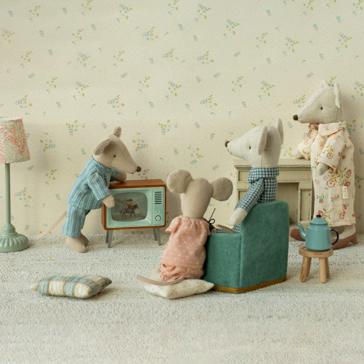 Maileg Toy mice in a living room setting with a floral wallpaper background and a Maileg Television