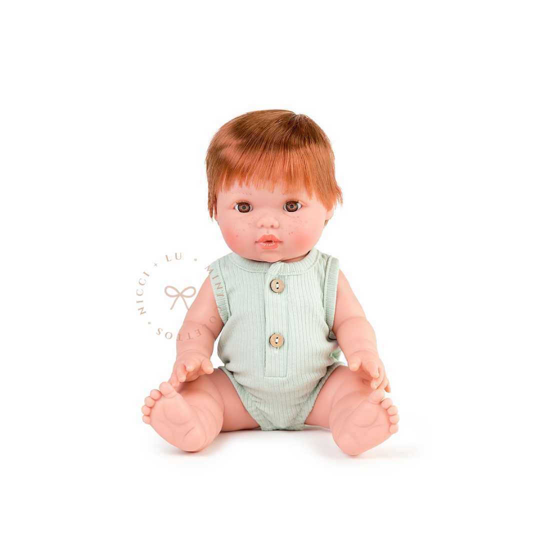 Jasper looks adorable dressed in a Luca ribbed bubble romper in sage green with front button detailing. His copper-red hair complements the gentle green colour, showcasing the 34cm Mini Colettos doll dressed for imaginative play.