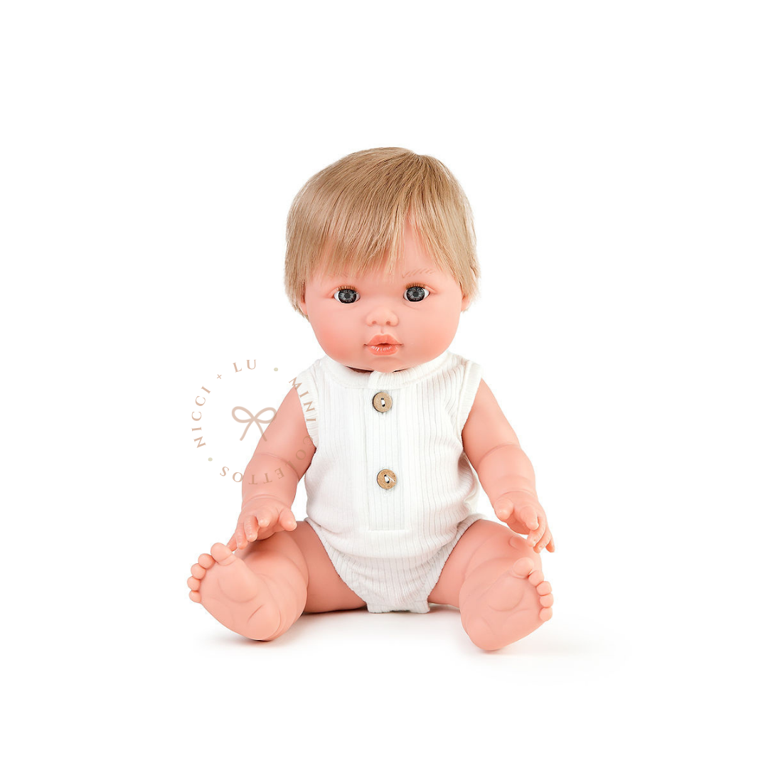 Oliver looks adorable dressed in a Luca ribbed bubble romper in ivory with front button detailing. His blonde hair and sweet expression complete this charming outfit, showcasing the 34cm Mini Colettos doll styled for imaginative play.