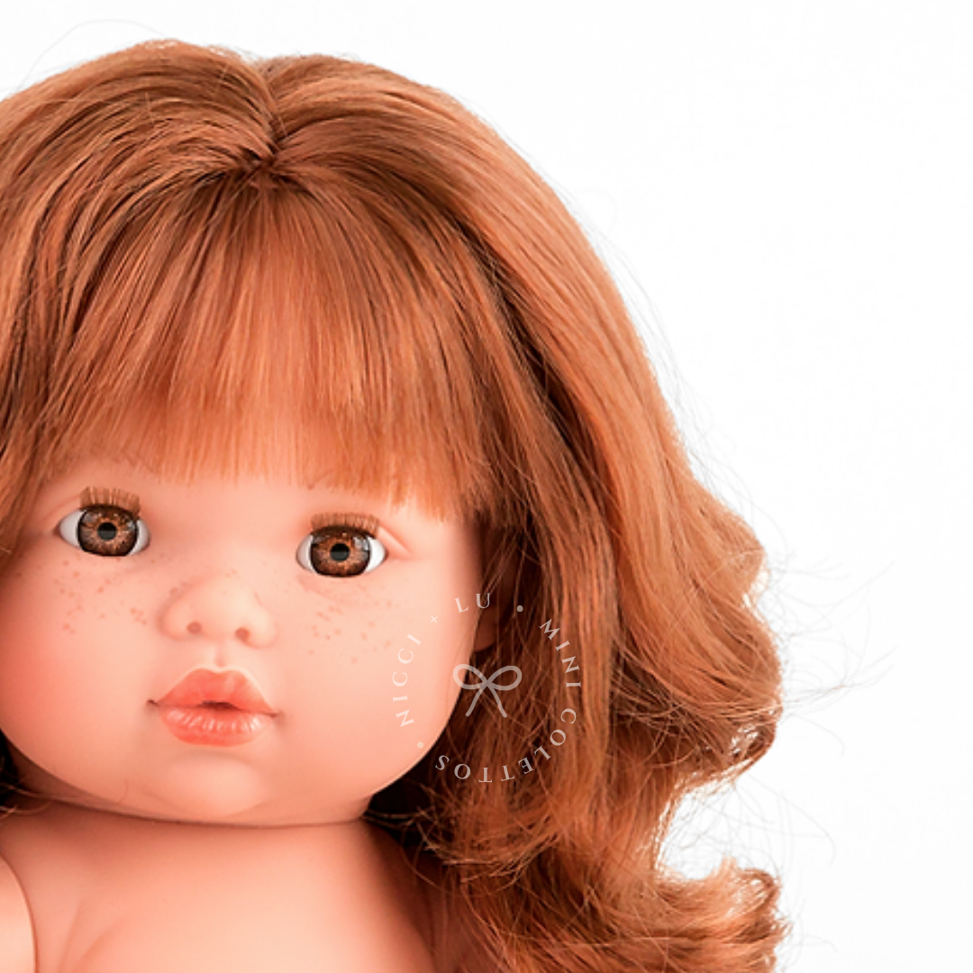 Sophia's sweet freckles, expressive brown eyes and gorgeous auburn-red curls are beautifully captured in this detailed portrait. Her distinctive facial features make this 34cm Mini Colettos doll a charming addition to any doll collection.