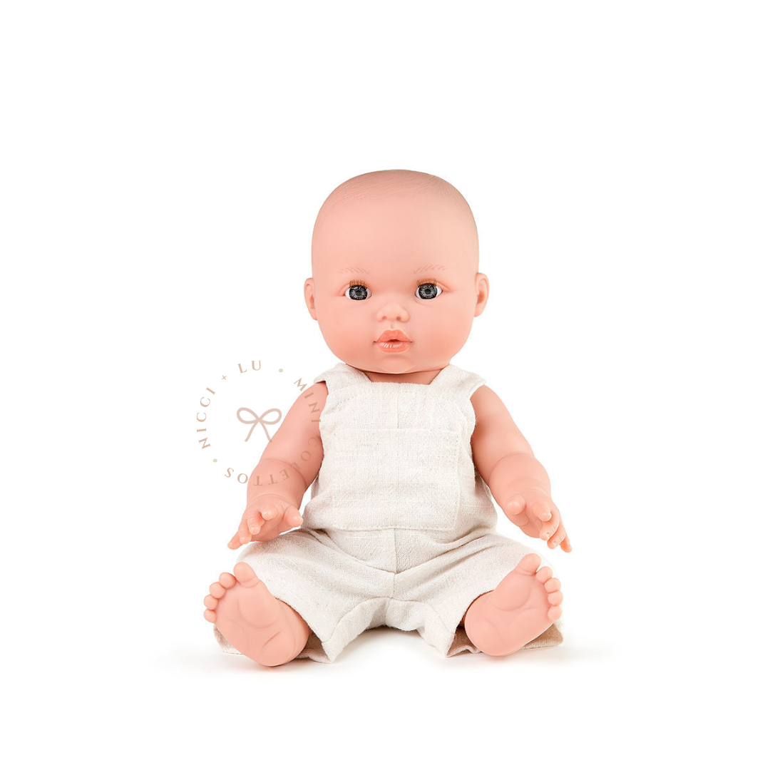 Thomas looks adorable dressed in a Oatmeal Linen Overall romper with a simple, timeless design. This styled photograph showcases the 34cm Mini Colettos bald doll wearing miniature clothing for imaginative baby care play.
 Copy both