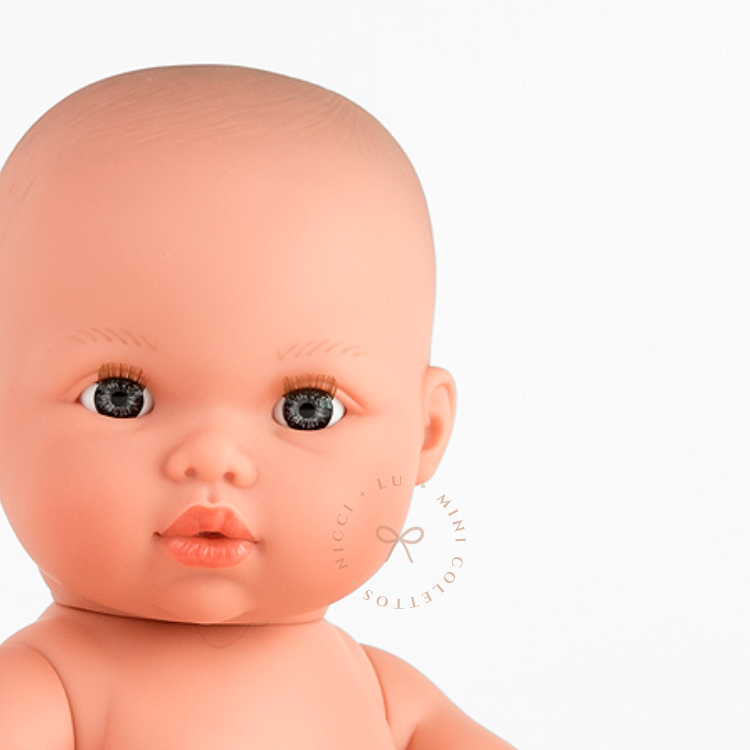 Thomas's beautiful blue-grey eyes, delicate eyelashes and sweet expression are captured in this detailed portrait. This photograph showcases the realistic facial features of the 34cm Mini Colettos Thomas doll.