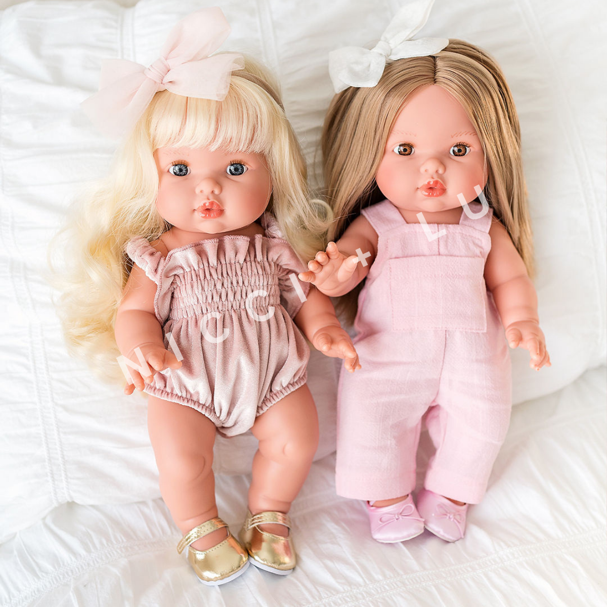 Mini Colettos Sage and Sandra wearing velvet smocked bubble romper and rose pink linen overall with matching 34cm doll shoes.