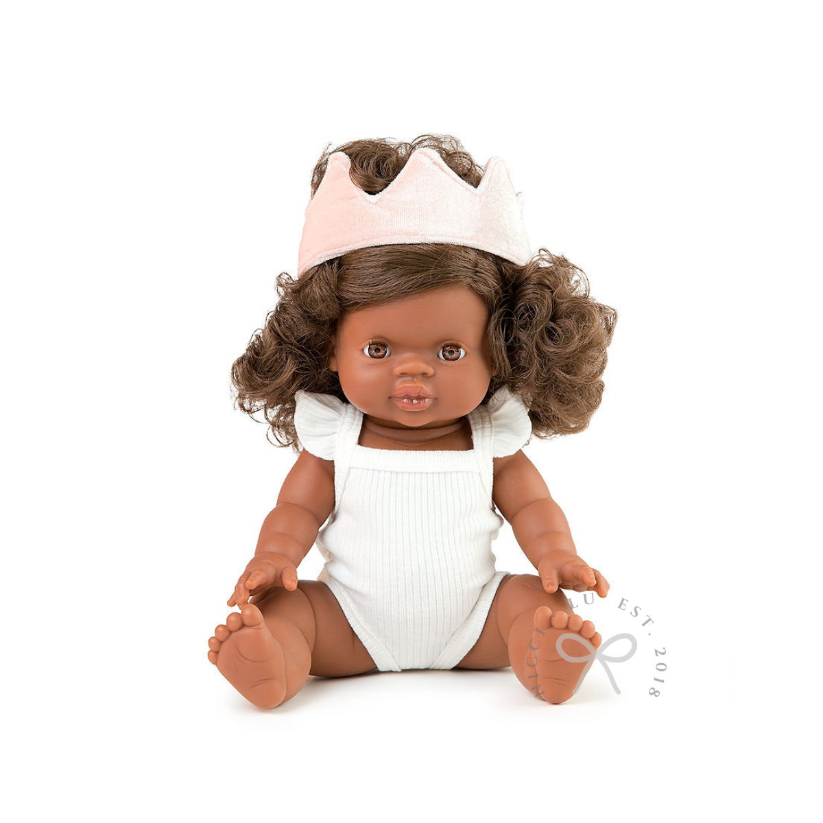 Doll with brown hair and a white outfit on a white background