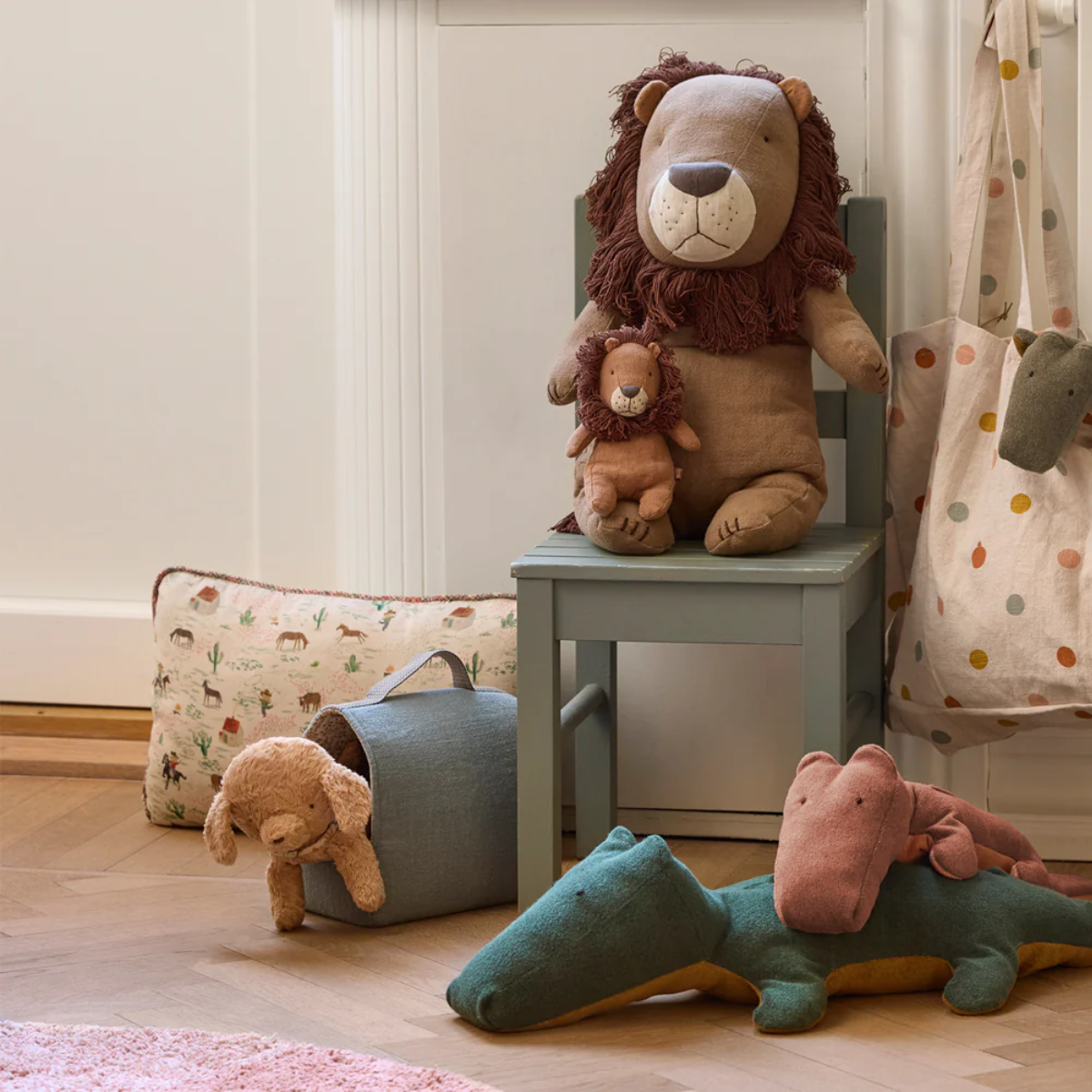 Children's room with plush toys including a lion, dog, and hippo on a chair and floor. Maileg puppy plush toy dusty powder 16cm