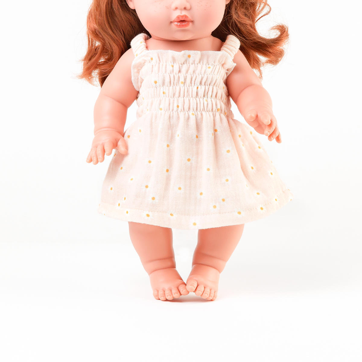 Front view of the Billie Smocked Dress in Daisy Print Muslin on Mini Colettos Sophia.