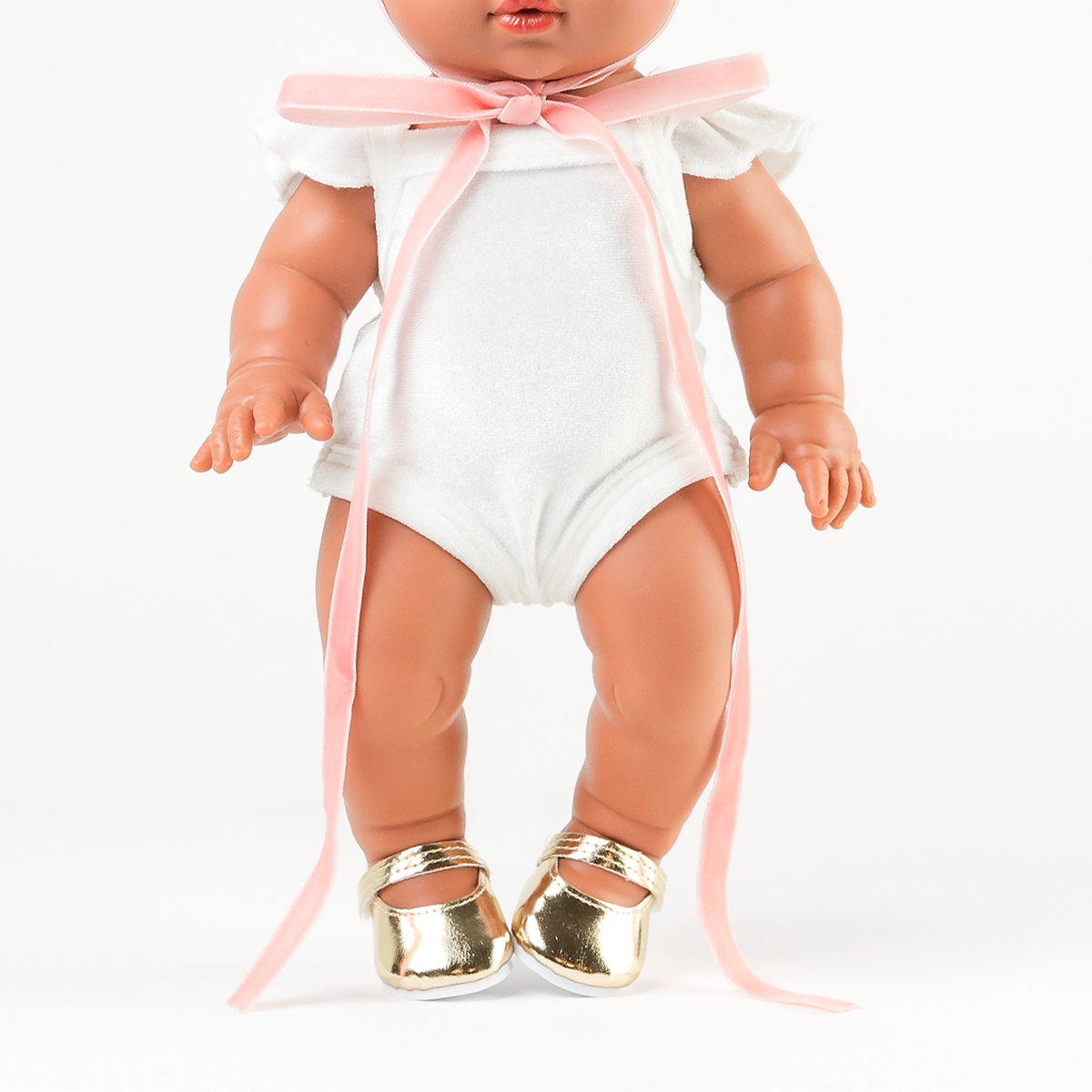 Close-up of Mini Colettos Alba wearing the Ivory Frilled Velvet Singlet Bodysuit with Gold Mary Jane Shoes.