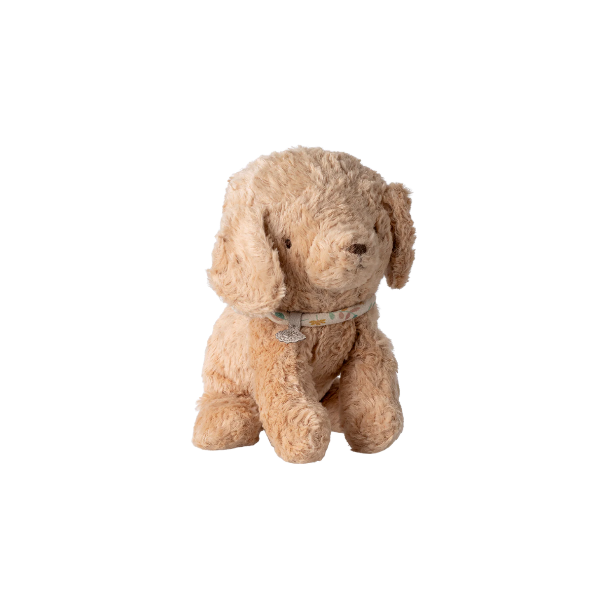 Beige stuffed dog toy on a white background Soft plush Maileg puppy in dusty powder colour with curly vintage-style fur and a delicate floral collar sitting upright.