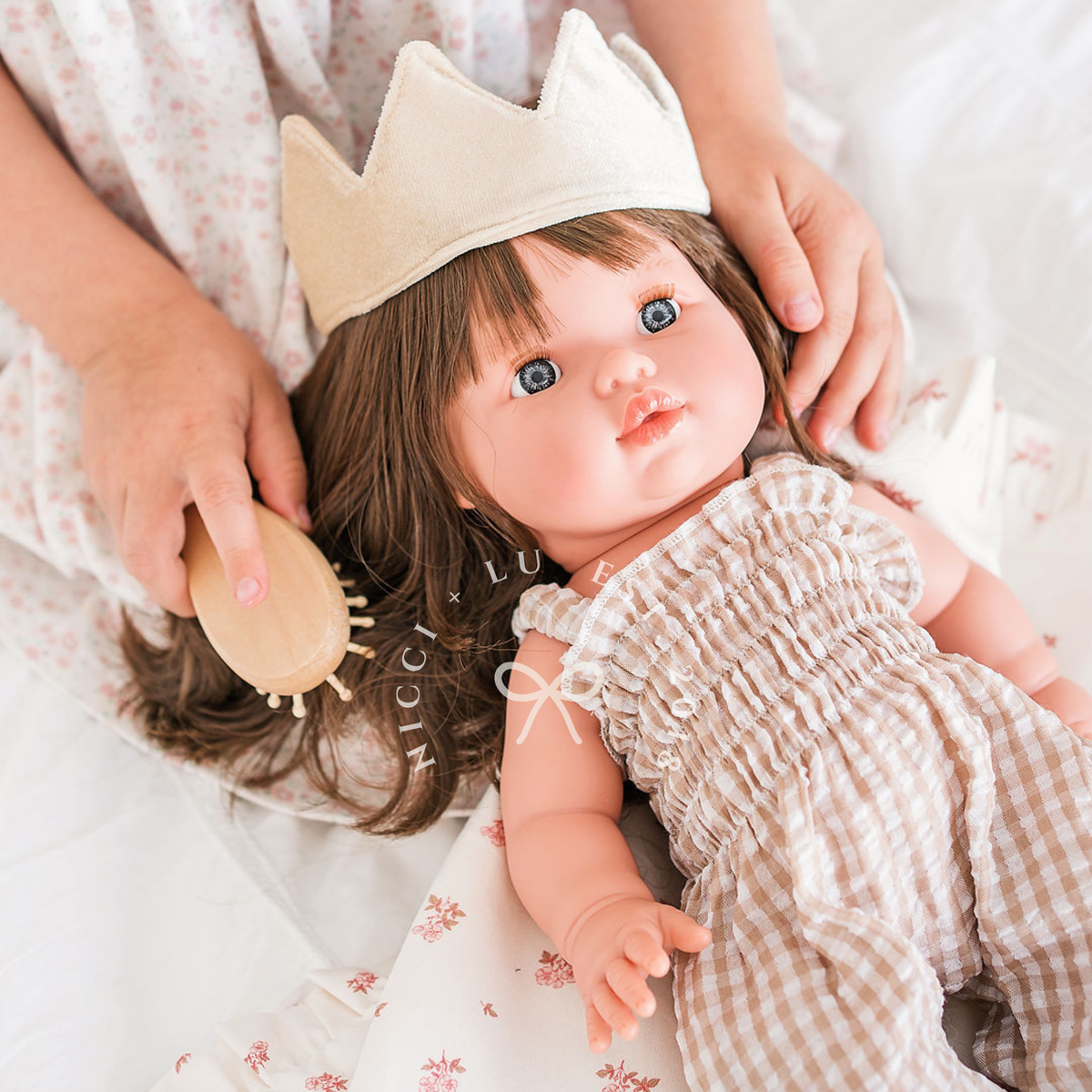 Mini Colettos Hailee wearing the Florence Smocked Jumpsuit in Beige Gingham with a Beige Velvet Crown.