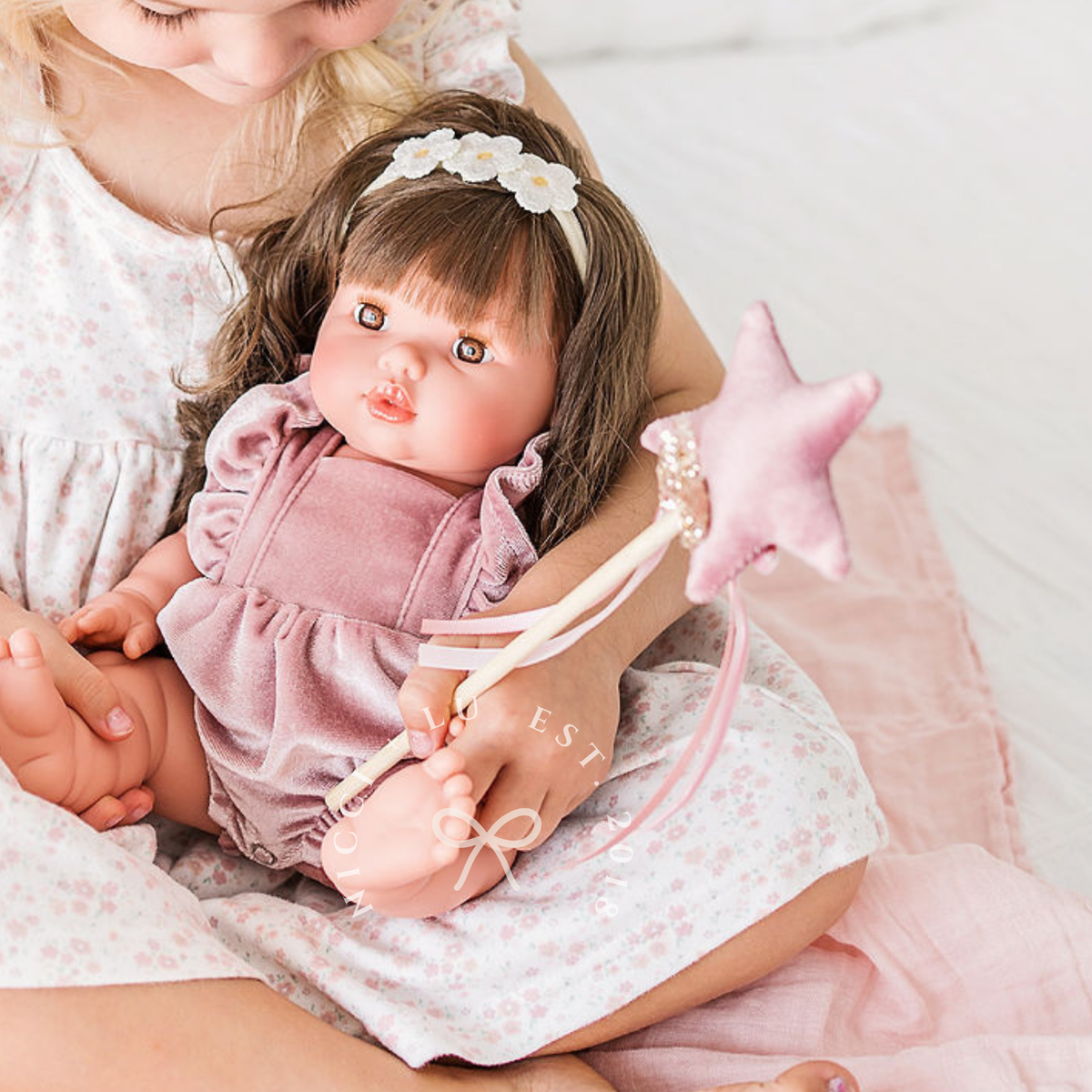 Mini Colettos Hailee wearing the Rose Blush Frilled Bubble Playsuit while holding a fairy wand.