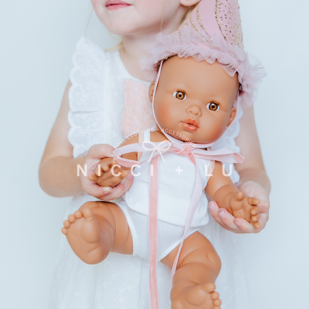 Mini Coletto Alba doll wearing party hat accessory
