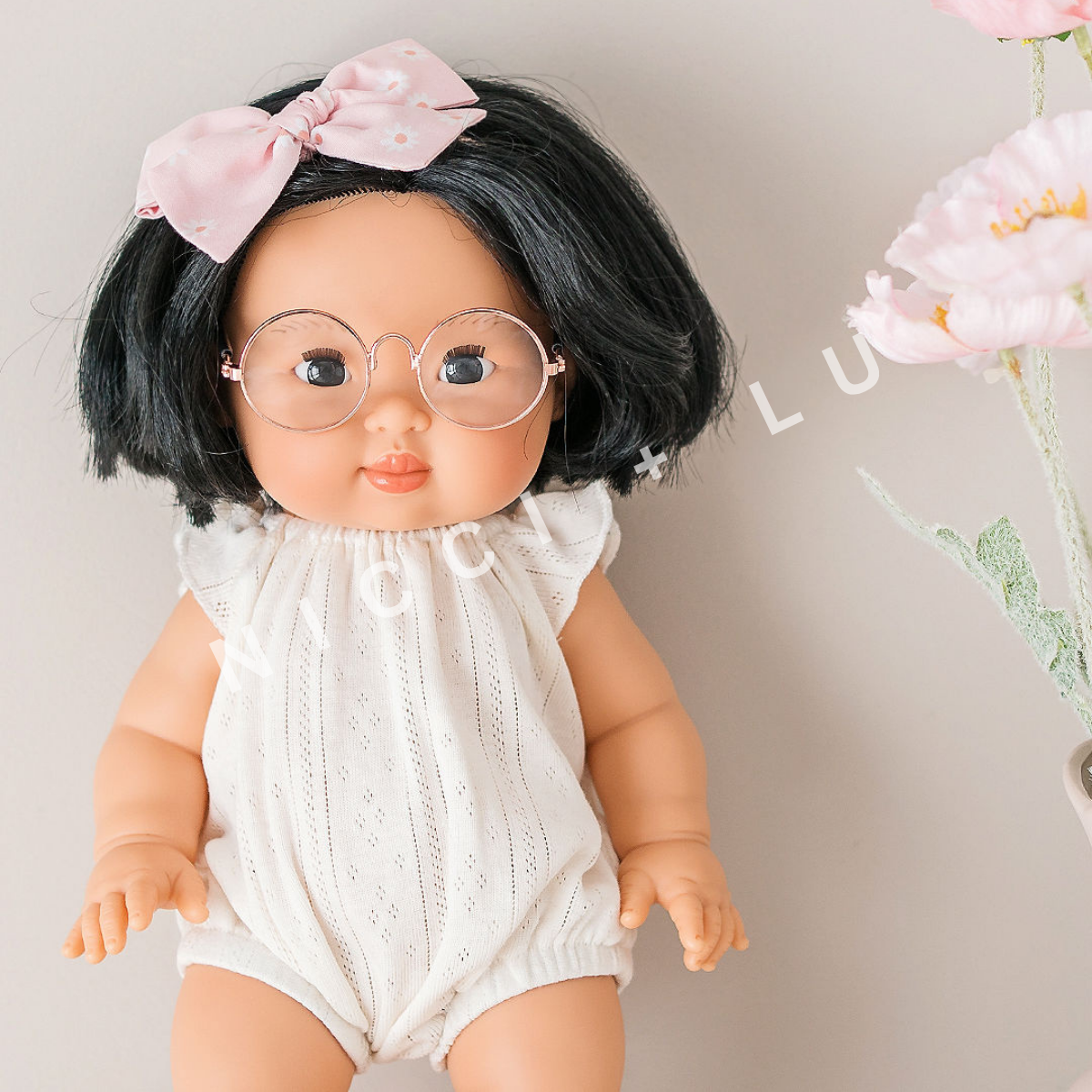 Ivory pointelle romper doll clothes on a white background