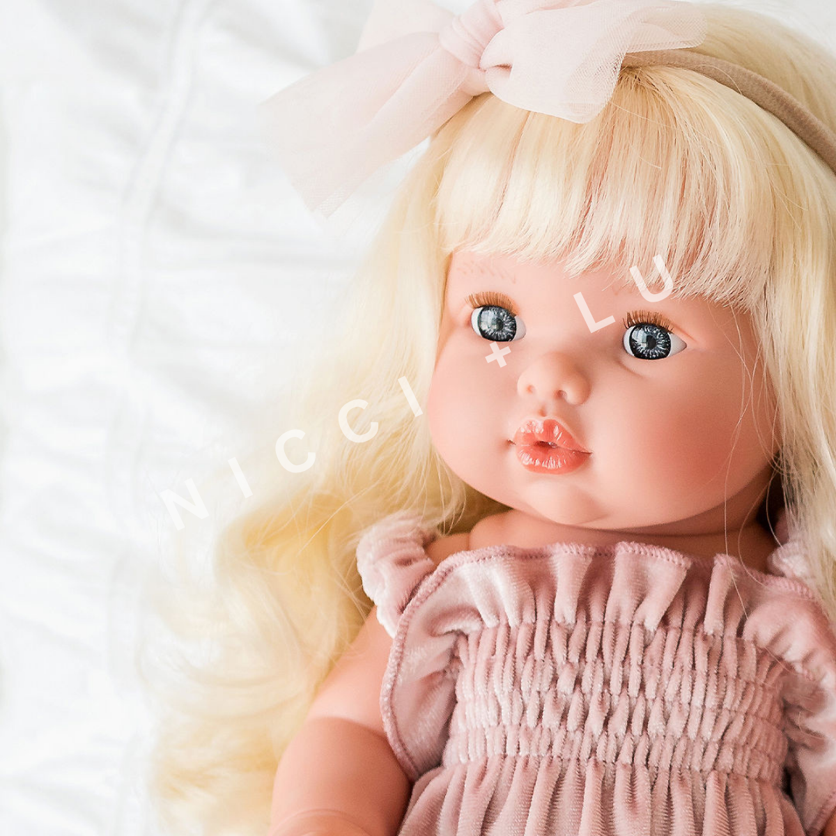 nicci and lu mini coletto doll sage wearing a smocked bubble romper in rose blush velvet 34cm doll clothing