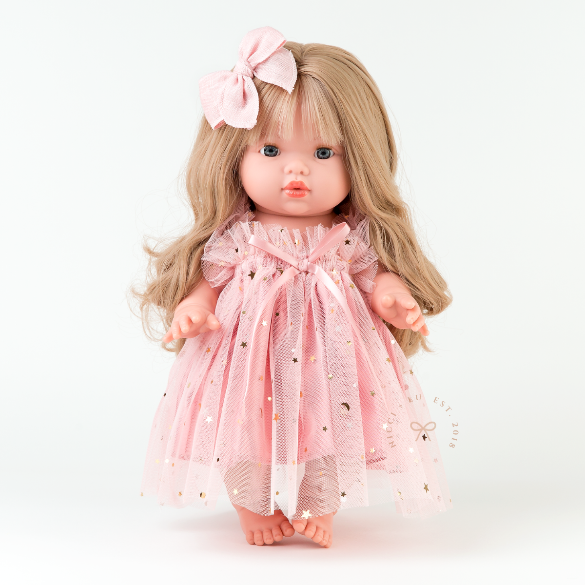 Mini Colettos Lyla doll wearing the Rose Blush Doll Tulle Ballet Dress with matching fable bow.