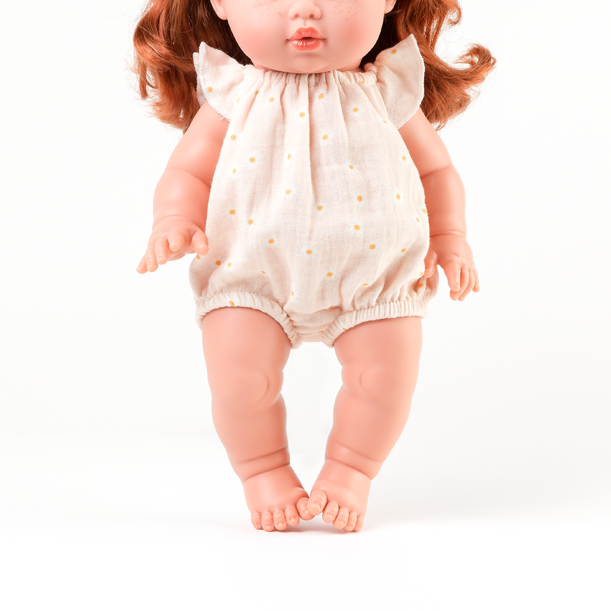 Front view of the Willow Muslin Romper in Daisy Print on34cm Mini Colettos doll Sophia.